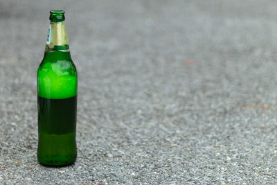 Close-up of beer bottle on glass