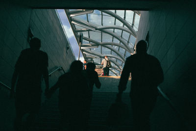 Rear view of silhouette people at subway station