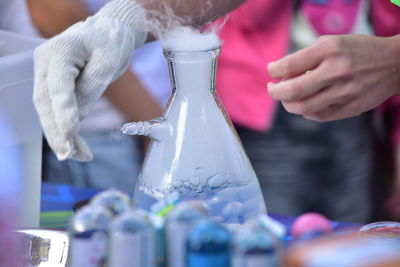 Close-up of hand holding glass bottle