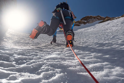 People skiing on snowcapped mountain against sky