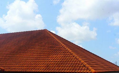 Low angle view of building roof against sky