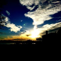 Silhouette buildings against sky during sunset