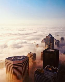 Aerial view of buildings against cloudy sky during sunset