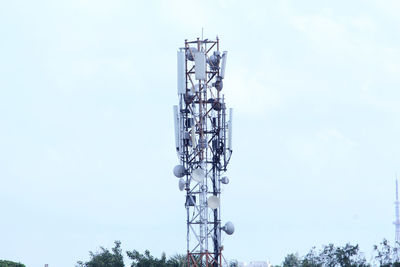 Low angle view of communications tower against sky