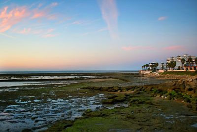 Scenic view of beach against sky during sunset