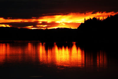 Scenic view of lake against romantic sky at sunset