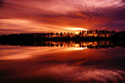 Scenic view of lake against romantic sky at sunset