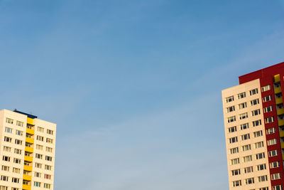 Two skyscrapers face each other on a sunny day