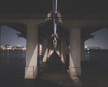 Illuminated lamp against sky at night