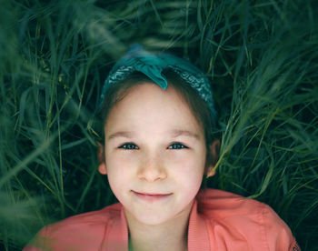 Directly above portrait of girl lying on grass