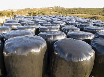 Stack of stones on field against sky