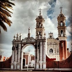 Low angle view of church against cloudy sky