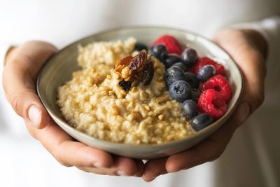 Midsection of person holding breakfast in bowl