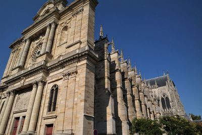 Low angle view of historical building against blue sky