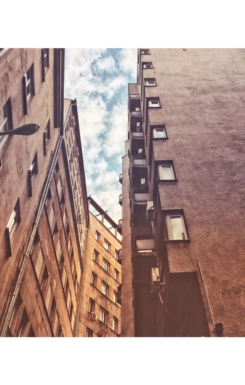 LOW ANGLE VIEW OF APARTMENT BUILDING AGAINST SKY