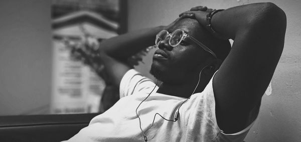 Man wearing eyeglasses resting at home