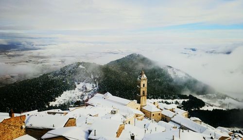 Panoramic view of snow covered trees against sky