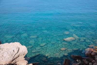 High angle view of rocks by sea