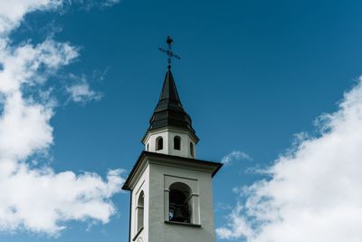 Low angle view of church against blue sky during sunny day