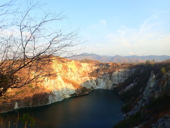 Scenic view of river amidst trees against sky