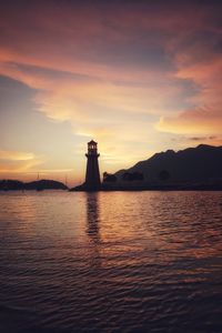 Lighthouse by sea against sky during sunset at langkawi,malaysia