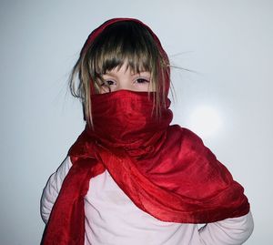 Portrait of woman covering face against white background