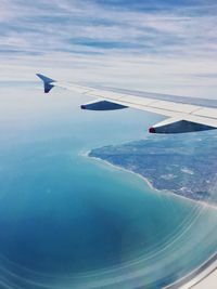 Aerial view of airplane flying in sky