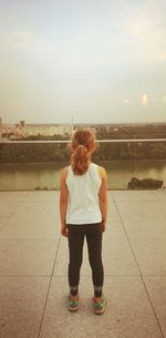 Rear view of woman standing against sky