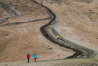 High angle view of people walking on road