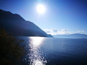 Scenic view of lake and mountains against clear sky