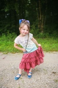 Portrait of cute girl standing on land