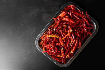 High angle view of red chili pepper against black background