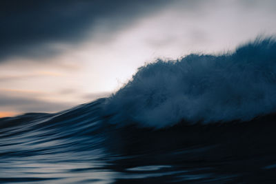 Wave breaking under the sunset taken with long exposure