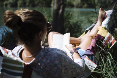 Rear view of couple sitting on book