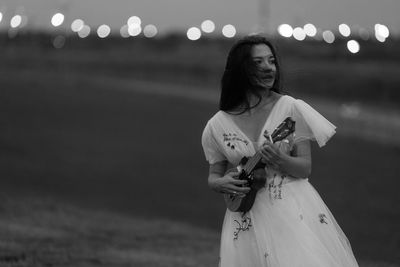 Young woman standing on road