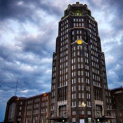 Low angle view of building against cloudy sky