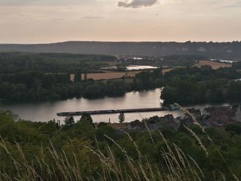 Scenic view of lake against sky at sunset