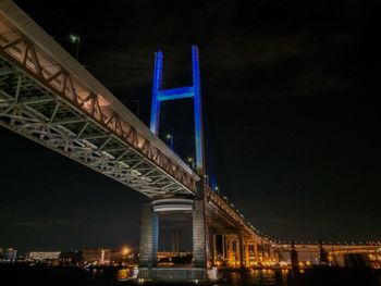 Low angle view of suspension bridge at night