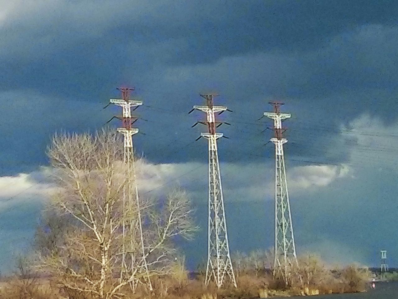 fuel and power generation, technology, sky, wind turbine, wind power, alternative energy, windmill, environmental conservation, renewable energy, cloud - sky, low angle view, electricity, cloudy, electricity pylon, communications tower, landscape, field, communication, nature, weather