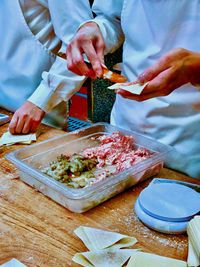 People preparing food on table