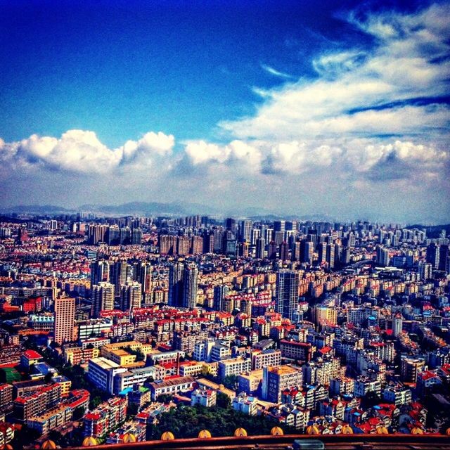 cityscape, city, building exterior, architecture, crowded, built structure, sky, high angle view, residential district, cloud - sky, skyscraper, aerial view, cloud, blue, residential structure, tower, residential building, city life, no people, modern