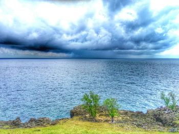 Scenic view of sea against cloudy sky