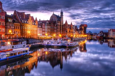 Reflection of buildings in river at night