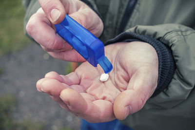 Man takes out a pill or candy in his palm