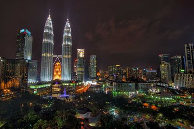 Illuminated cityscape against sky at night