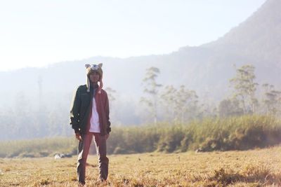 Full length of man standing on field against sky
