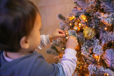 Close-up of boy blowing bubbles at home