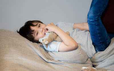 Woman lying on bed at home