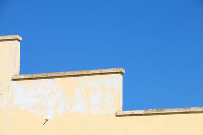 Low angle view of building against blue sky