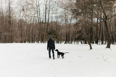 People with dog on snow covered land